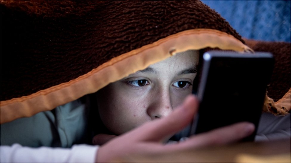 Most children sleep with mobile phone beside bed - BBC News